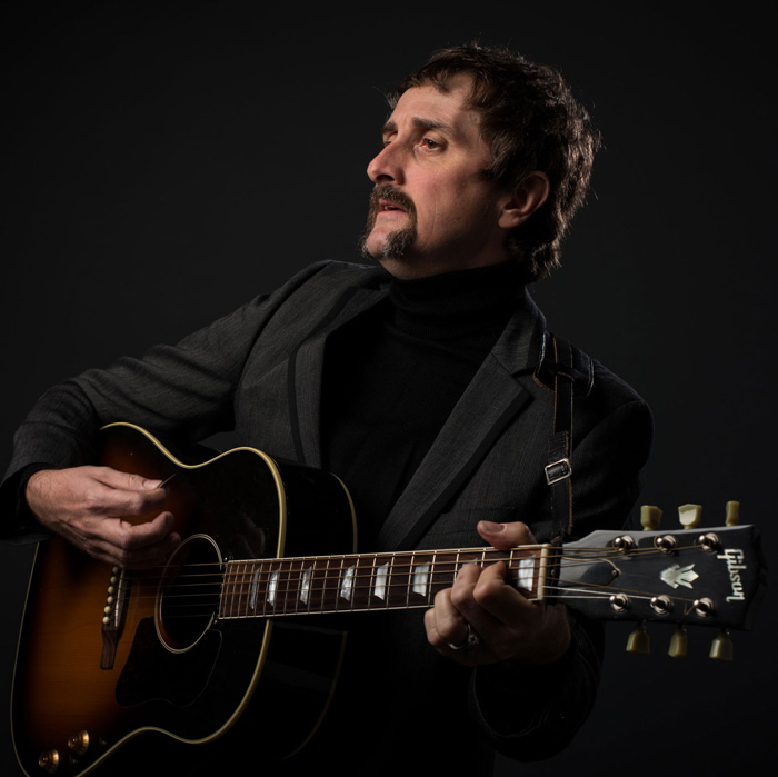 Marc Stewart plays guitar
